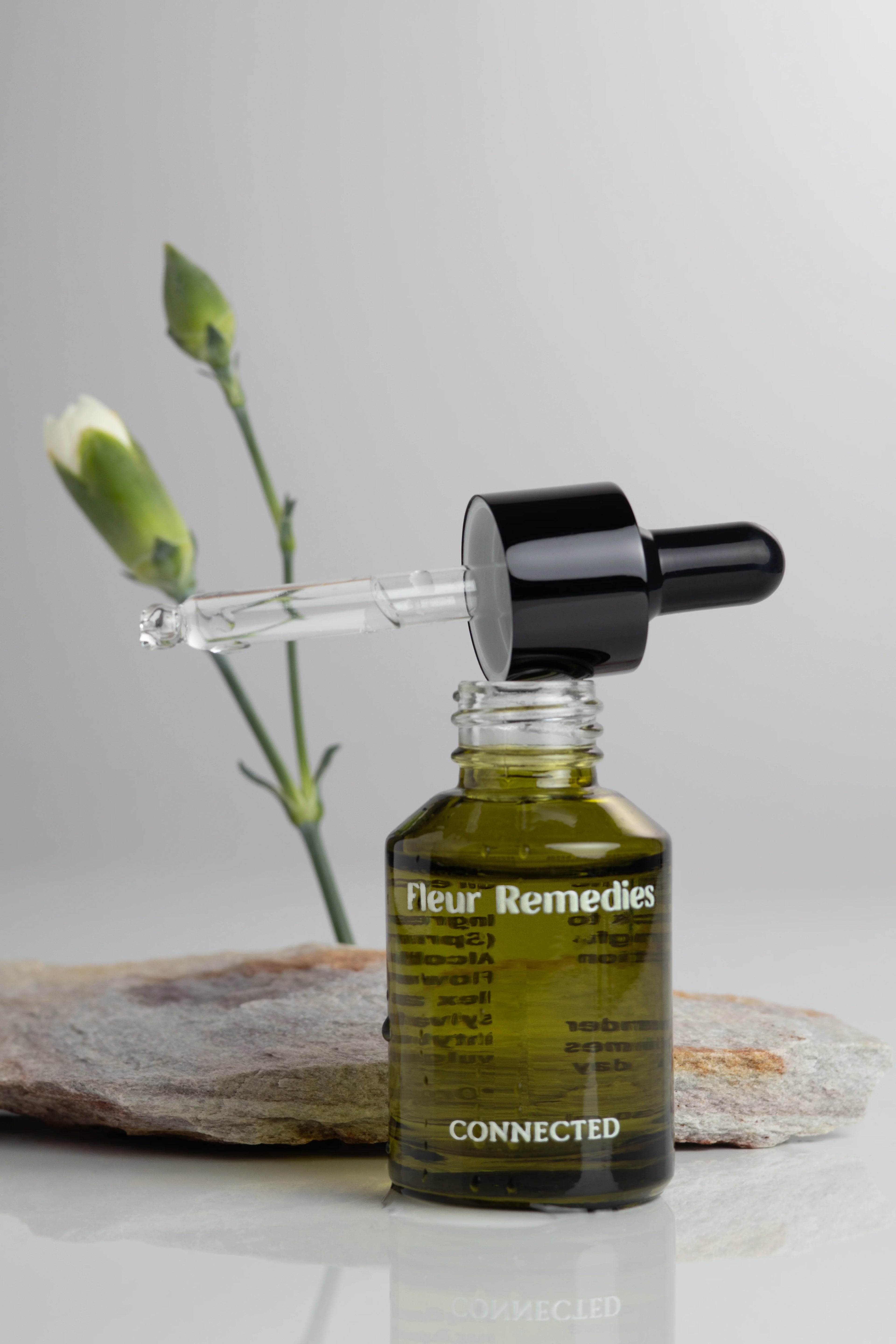 Bottle of Fleur Remedies Connected with dropper on a neutral background